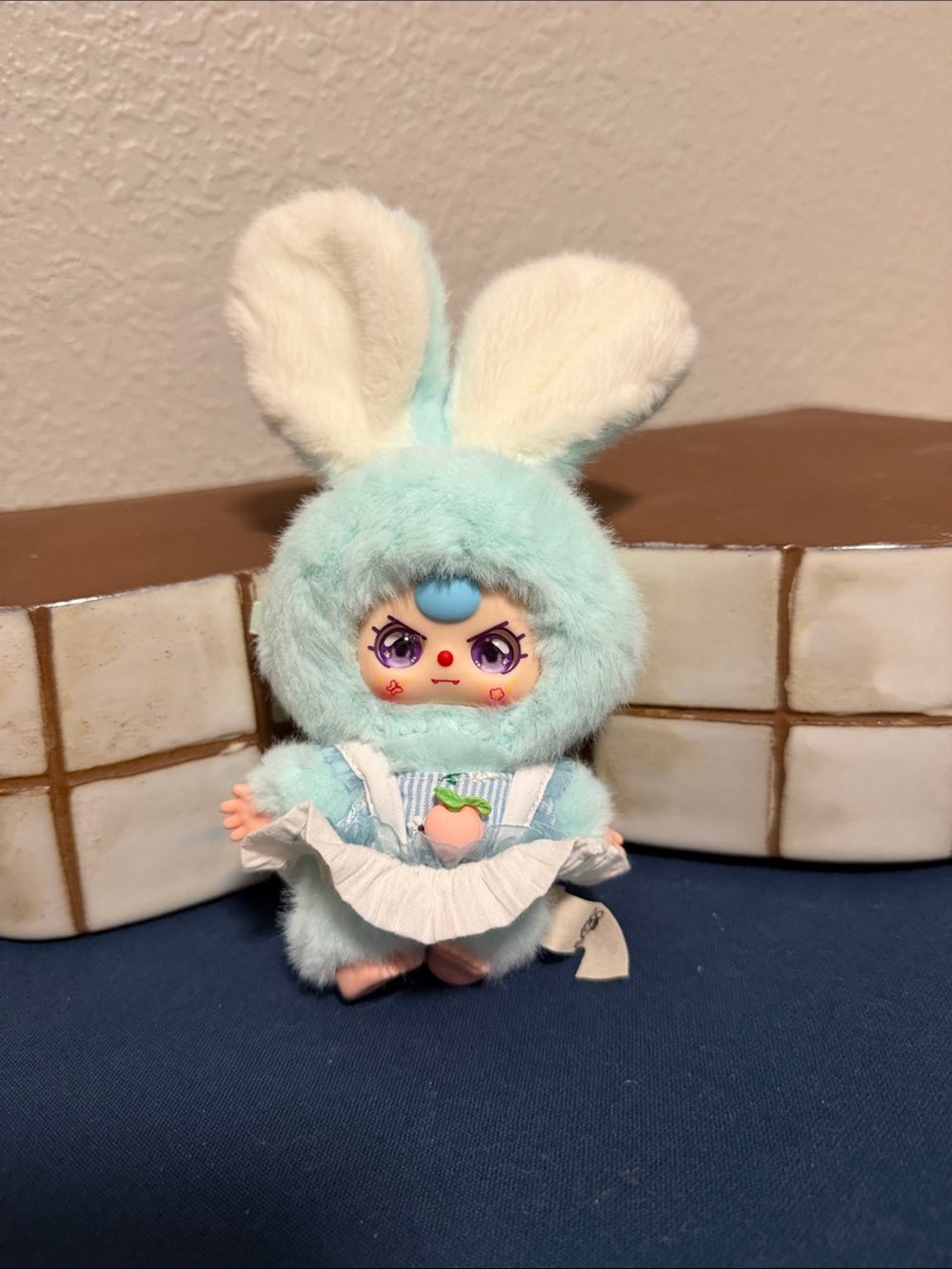 Baby Three 50% keychain with Peach dress in light blue